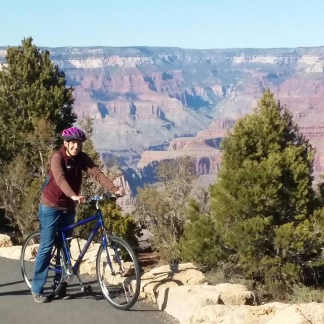 Person on Bike in front of Grand Canyon.