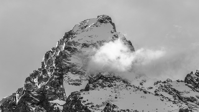 The Grand Teton peak with a wisp of a cloud below its top.