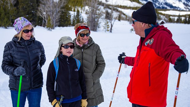 Volunteer ski ambassador talking to visitors