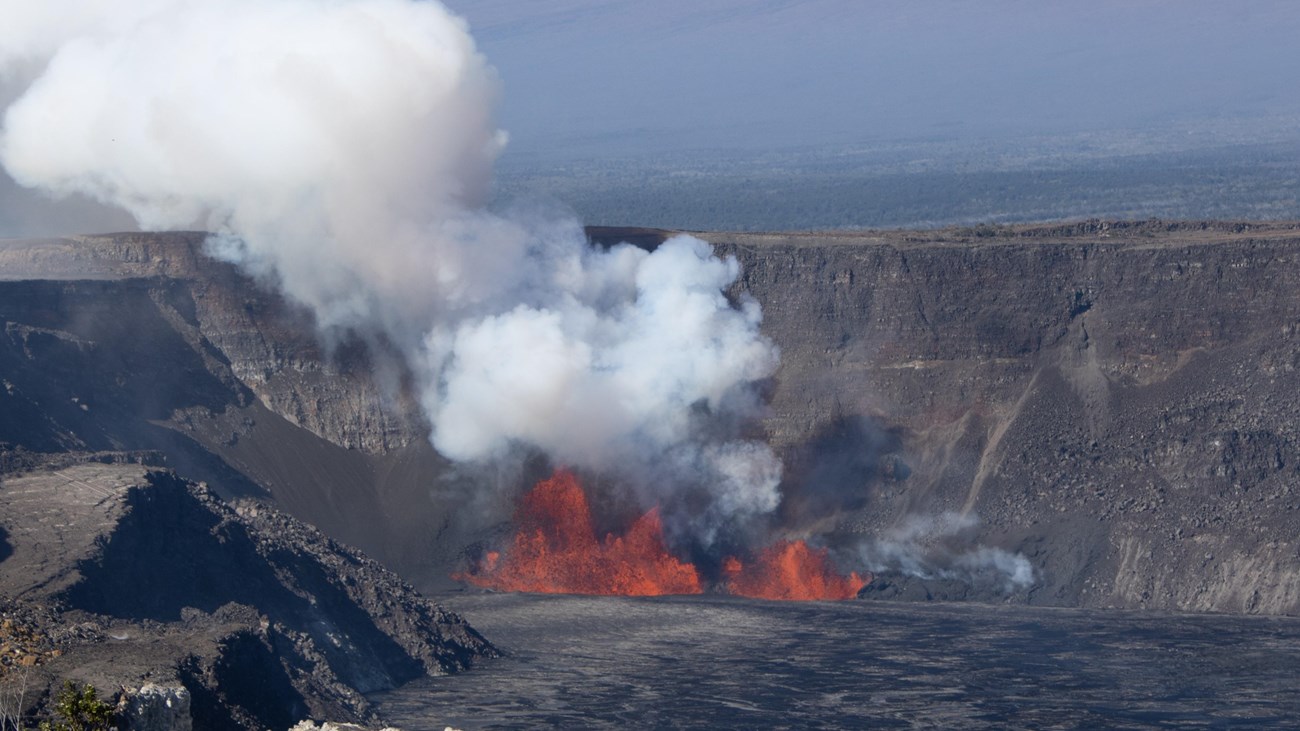 Image of bright orange lava fountains within a crater.