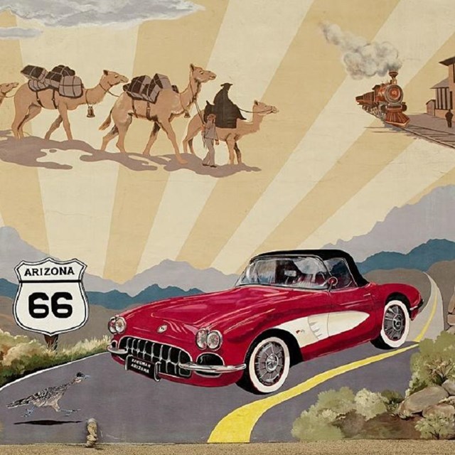 Mural of cars with Route 66 sign. 