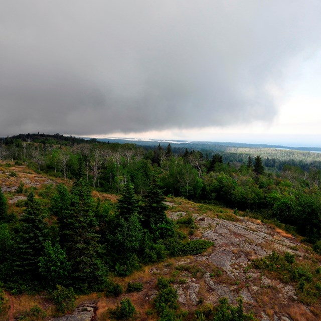 A dark gray storm cloud rolls over the Greenstone Ridge.