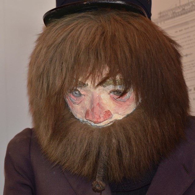 Close up of manikin face with bushy beard and hair.