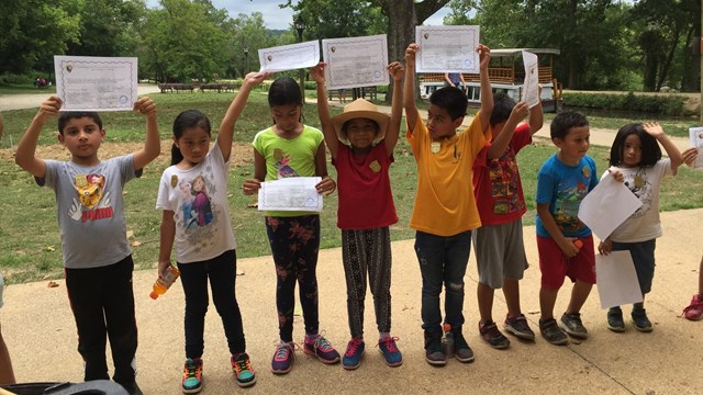 Students proudly holding their Junior Ranger Certificates.