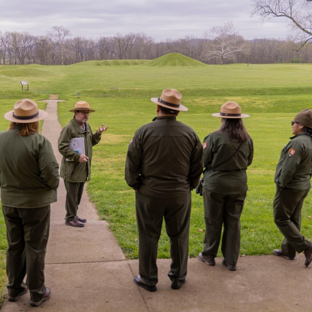 NPS Director Chuck Sams joins park staff learning about the mounds at Hopewell Culture