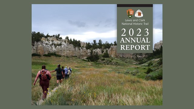 2023 Annual Report. Park Service Logo. Lewis and Clark Trail logo. photo people hiking