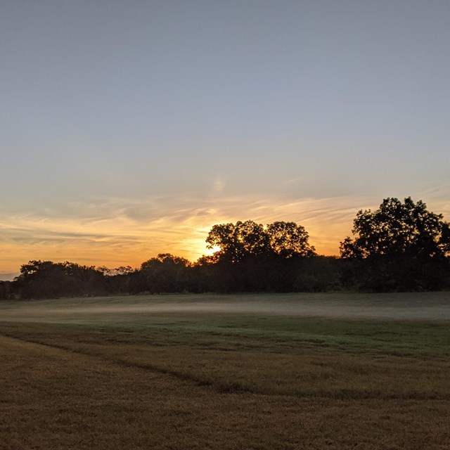 sunrise at the LBJ Ranch with fog on the horizon
