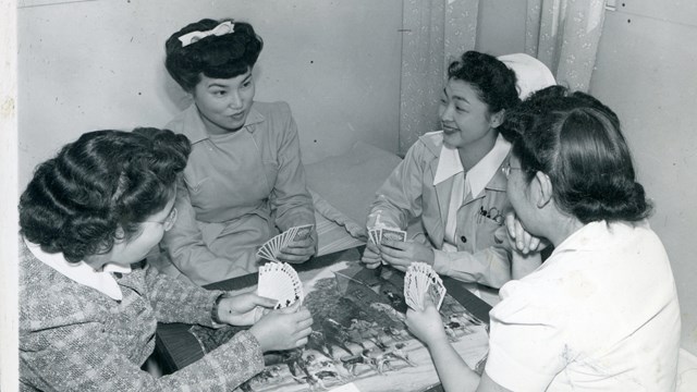 Historic image of four women playing cards