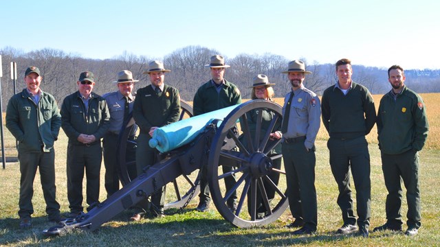 Park staff standing by a cannon