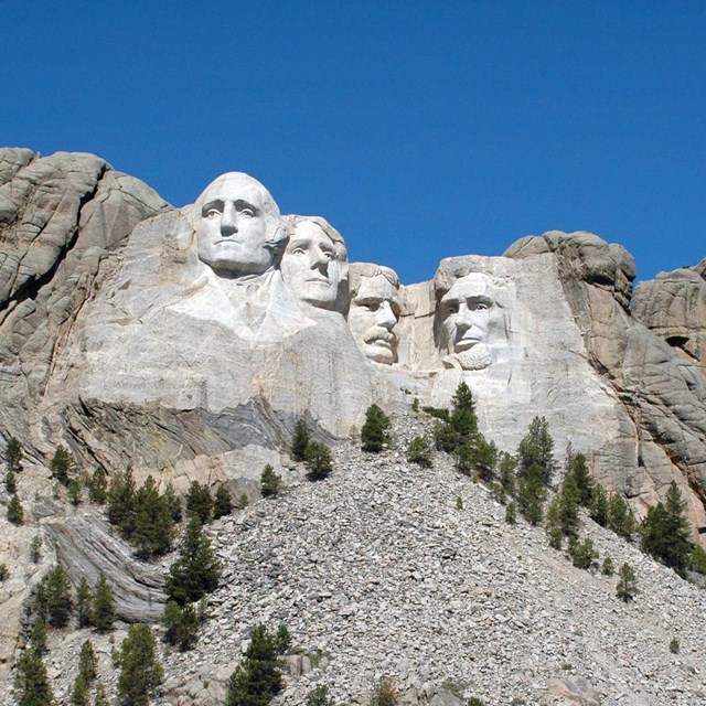 Photograph of Mount Rushmore under a clear blue sky.