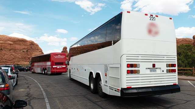 A large white bus in a parking lot