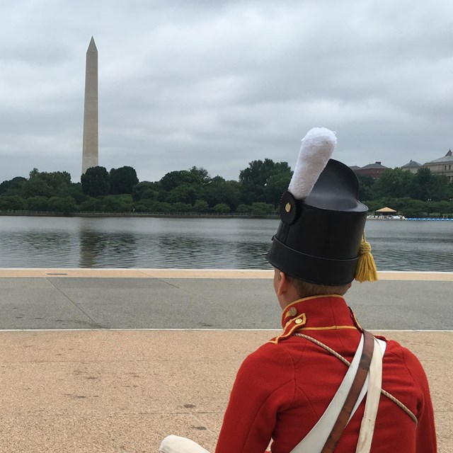 Two US Army Fife and Drum Corps soldiers looking at the Washington Monument