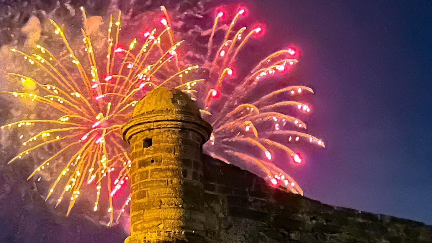 Colorful fireworks over a historical Spanish fort