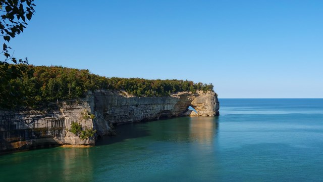 Sandstone cliffs over Lake Superior on a clear day.