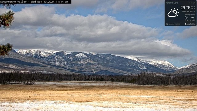 Webcam image from the Kawuneeche Valley with mountain peaks covered with recent snow