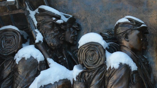 Sculpture of soldiers covered in snow