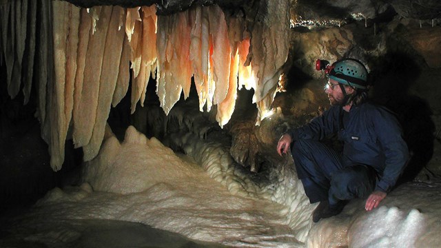 Cave Specialist views a park cave formation.