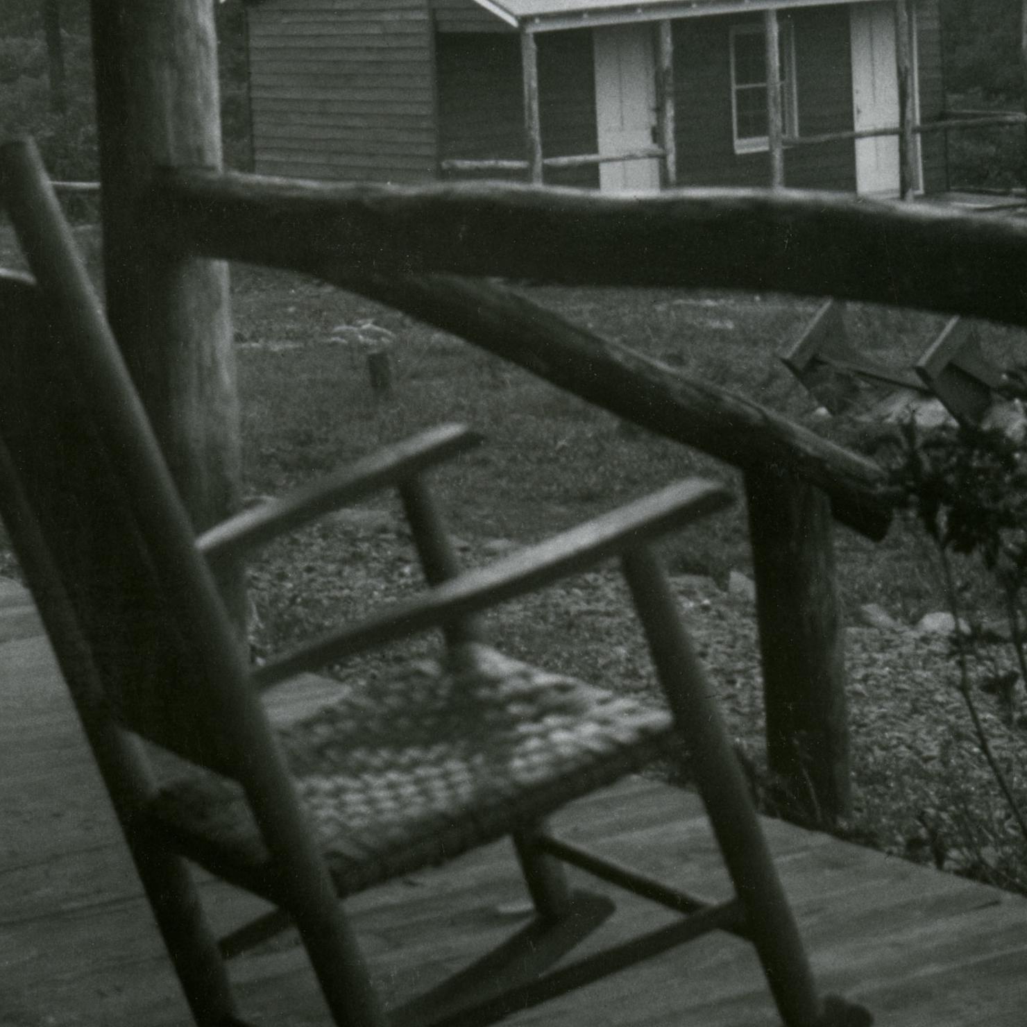 An amateur radio shack from unidentified porch with a rocking chair in foreground 