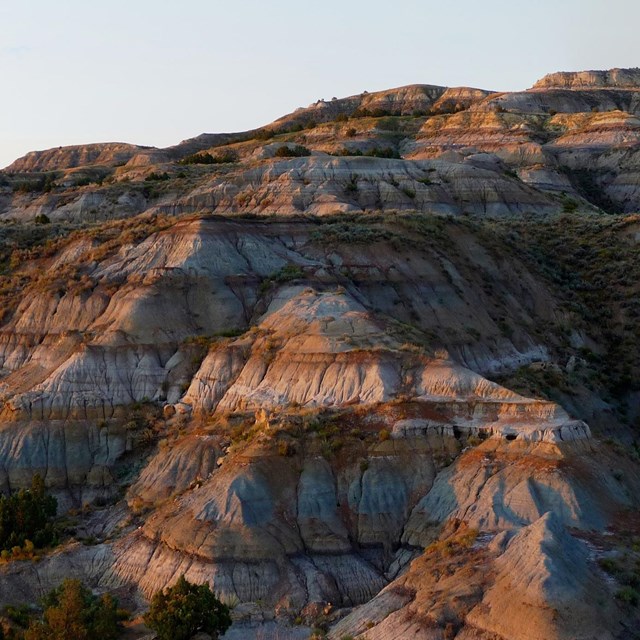Shadowed, striped buttes that engulf the entire image.