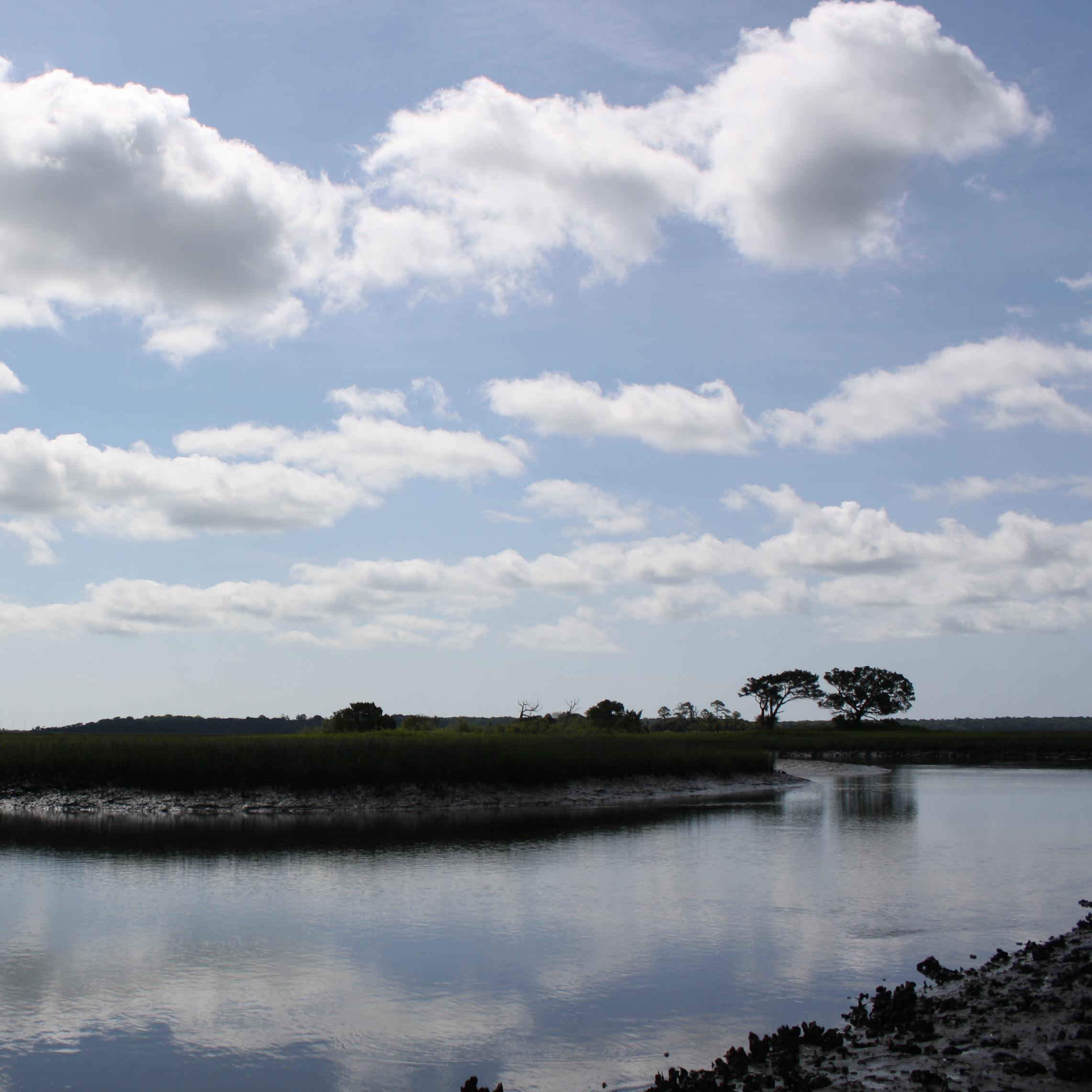 horseshoe bend in creek with clouds above