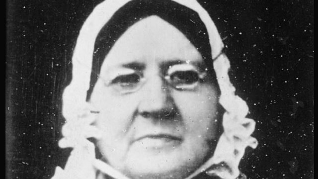 Photograph of Mary Pickersgill: small glasses, black hair, white bonnet 