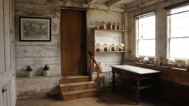 small, syrup room with whitewashed wooden walls
