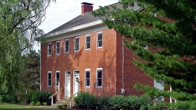 brick building featuring two white doors