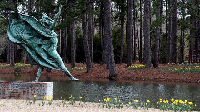 Statue of girl with clothes blowing in the wind. By anoldent - Brookgreen Gardens 42, CC BY-SA 2.0,