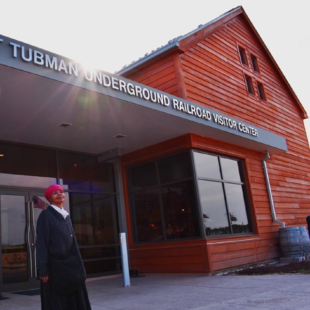 Visitor center with interpreter dressed as Tubman out front. Courtesy NPS. 