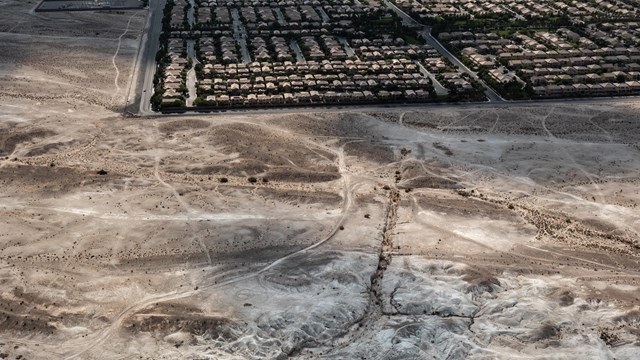 Aerial photo of a desert landscape meeting urban development.