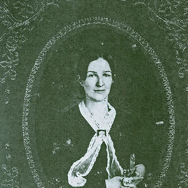 A black and white image of a woman in a dress