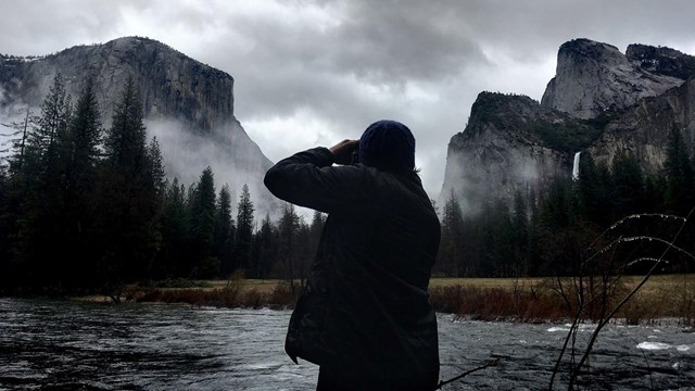 Person taking pictures from Valley View in Yosemite Valley
