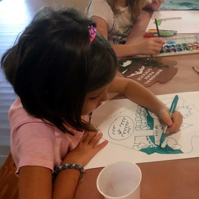 Girl scout working on art work. 