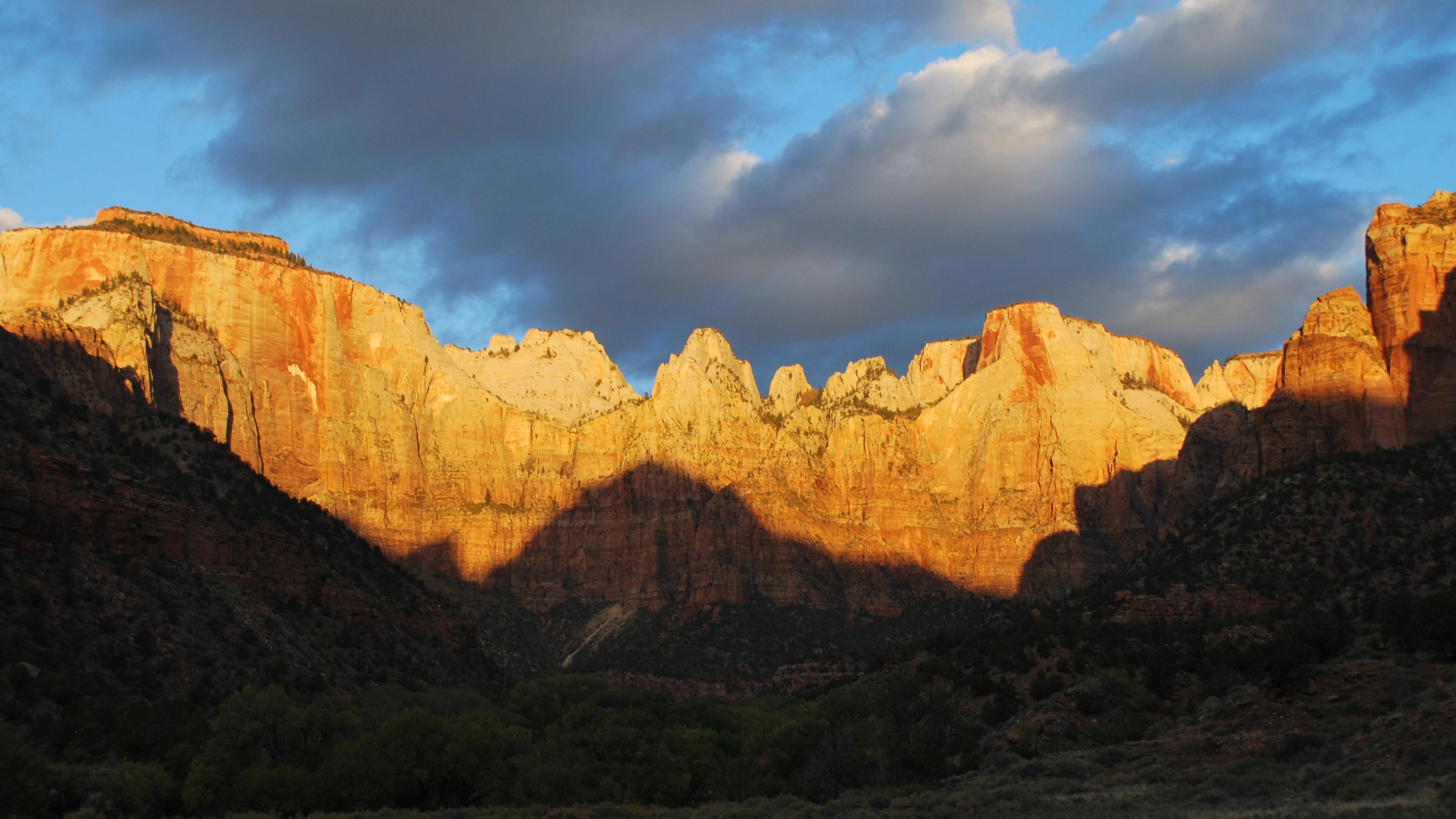Orange cliffs glow in the light of sunrise.