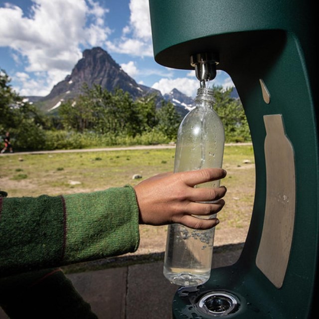 a water bottle filling station is used to refill a water bottle