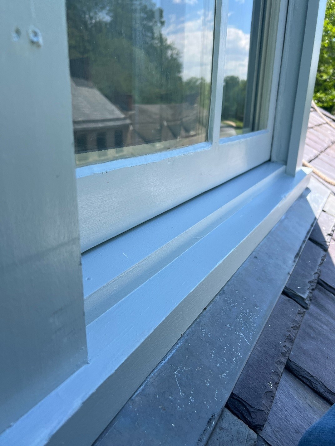 A window with a solid sill, painted white.