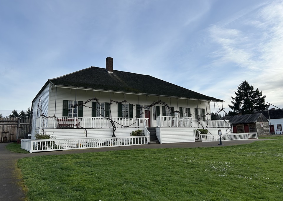 The reconstructed Chief Factor's House at Fort Vancouver. A white, two-story house with a long veranda along its front side.