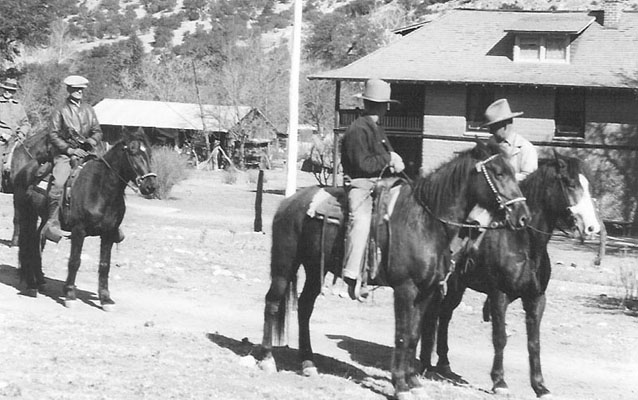 Faraway Ranch in 1919, with three people on horseback in front of ranch buildings 