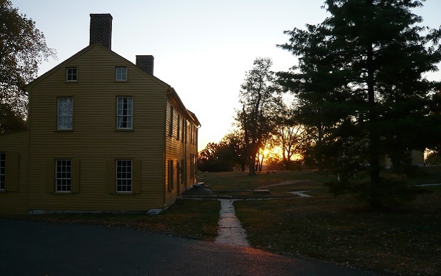 sunrise over a yellow shaker building