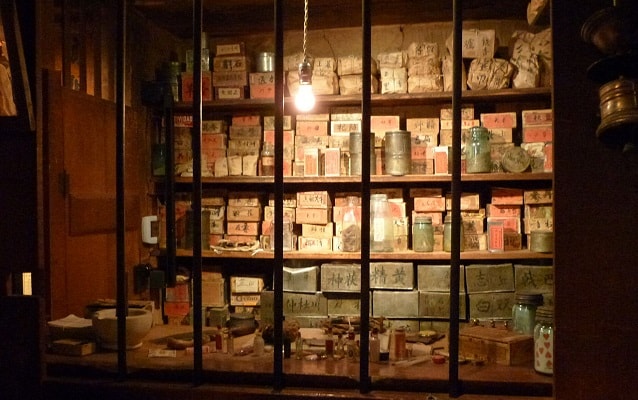 Window display of historic medicine bottles and boxes. 
