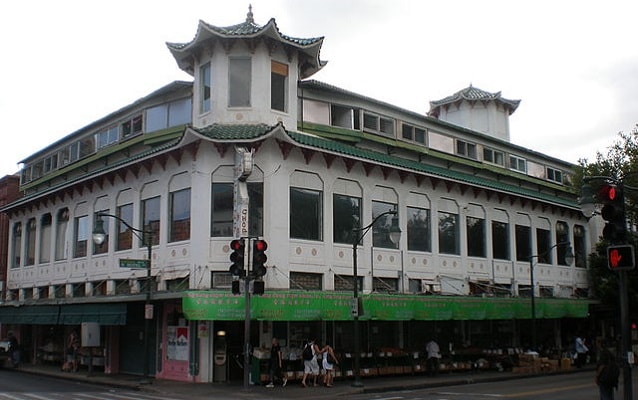 Wo Fat Building with large windows and green tiled roof. 