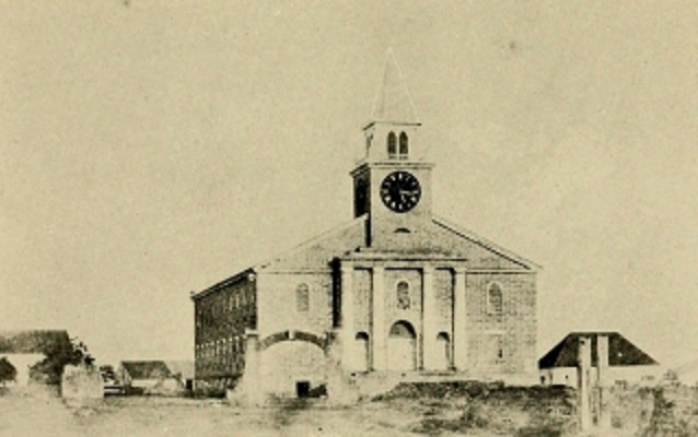 Black and white photo of a church with a cupola. 