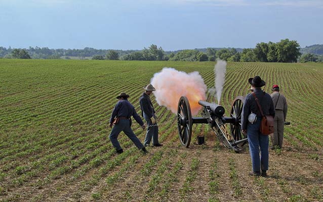 Living history reenactors firing a Civil War cannon at Monocacy