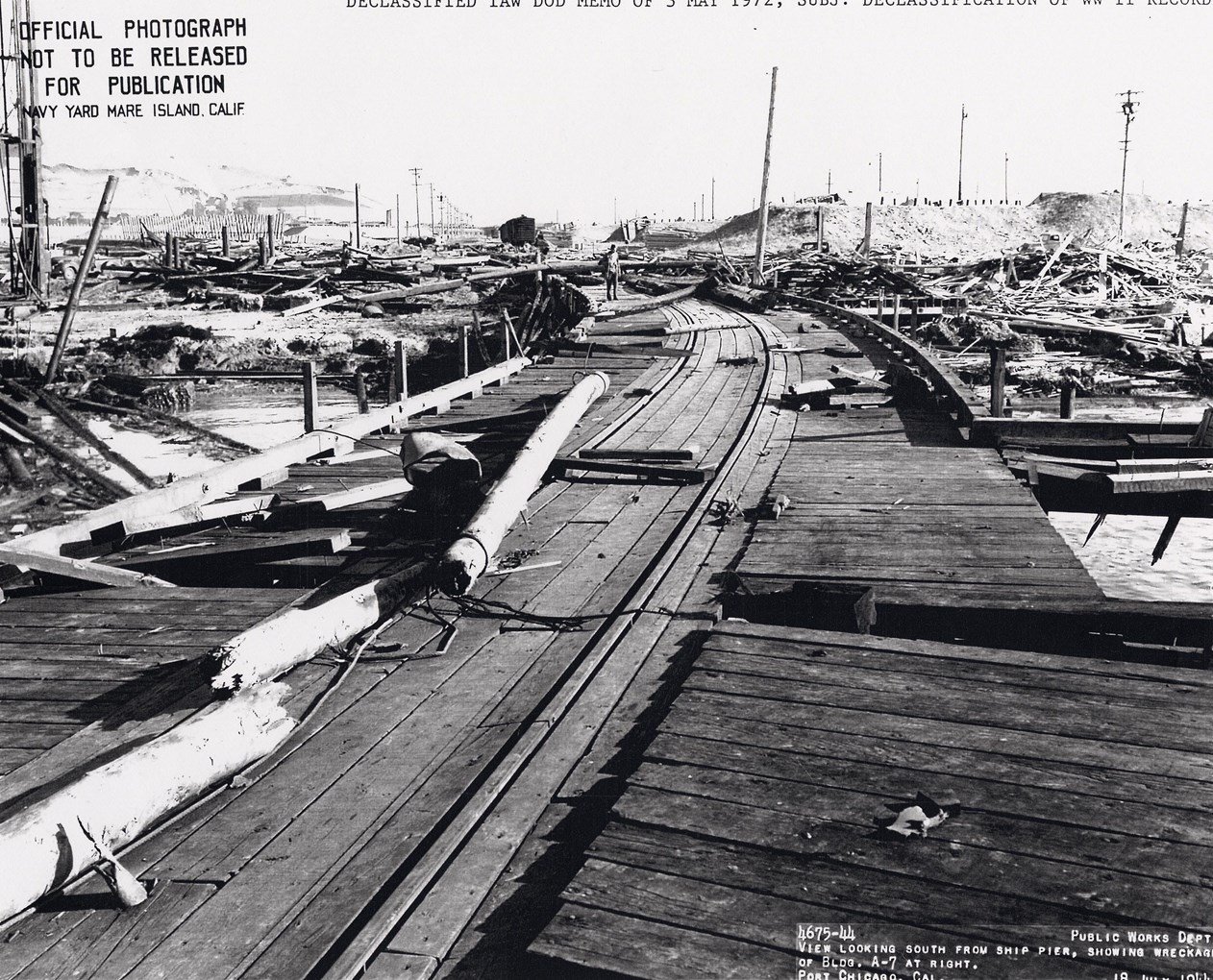 Historic Black and white photo of the disaster aftermath. Railroad tracks and debris.