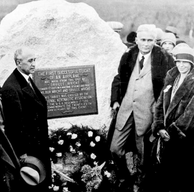 L to R- Orville Wright, Hiram Bingham, Amelia Earhart in front of boulder, 1928