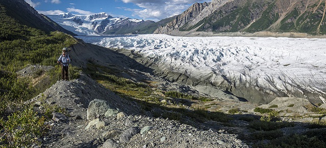A hiker walks on an old lateral moraine of the Root Glacier (Wrangell-St. Elias National Park, AK)