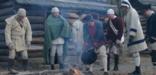Reenactors try to stay warm outside soldier huts in Jockey Hollow