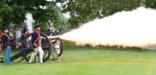 Visitors watch a cannon firing demonstration