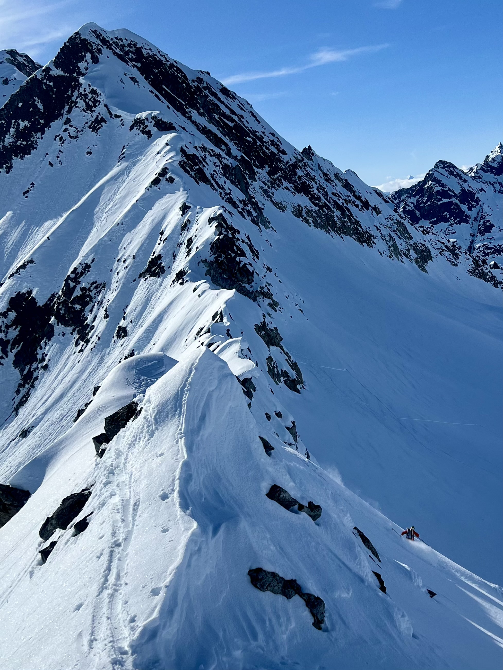 Corniced ridge with ski tracks in the snow