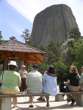 Volunteer giving program in front of Devils Tower